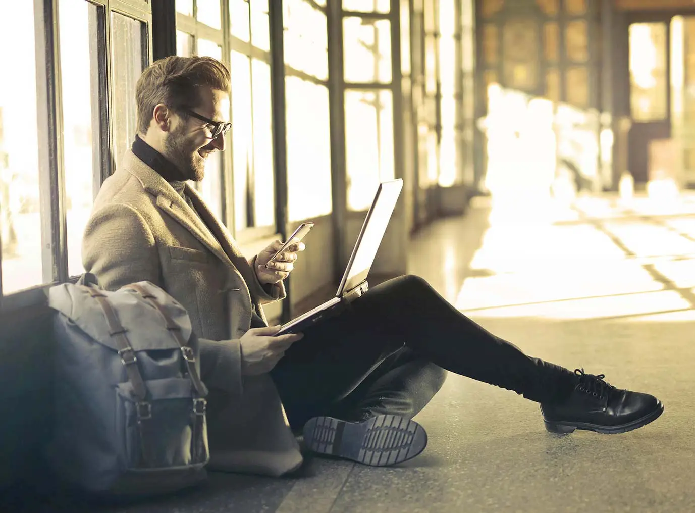 UK business owner reviewing financial documents and loan statements at desk with calculator